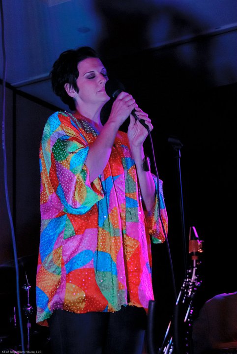Vocalist performing in a colorful stage outfit