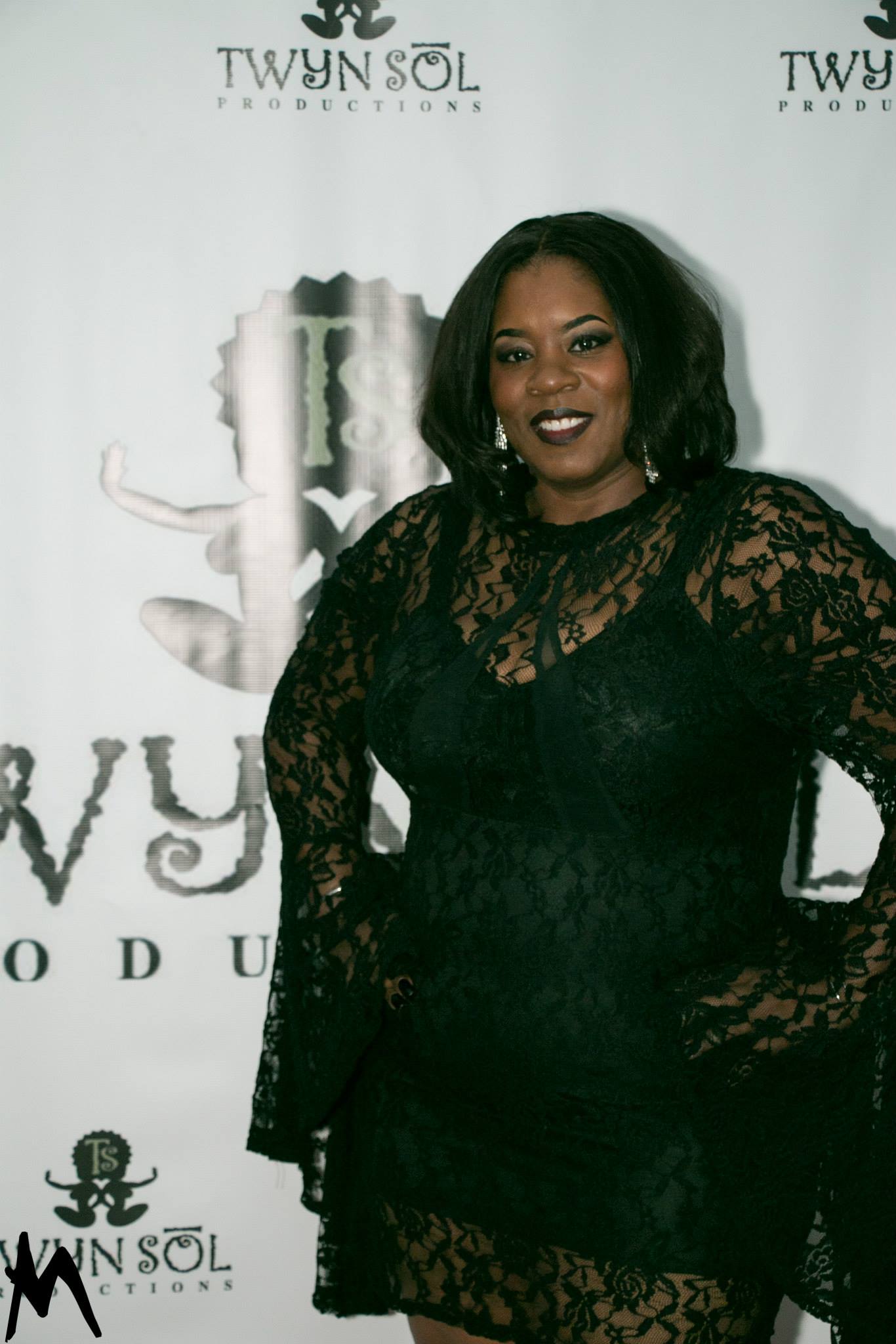 Guest posing at the Twyn Sol event backdrop
