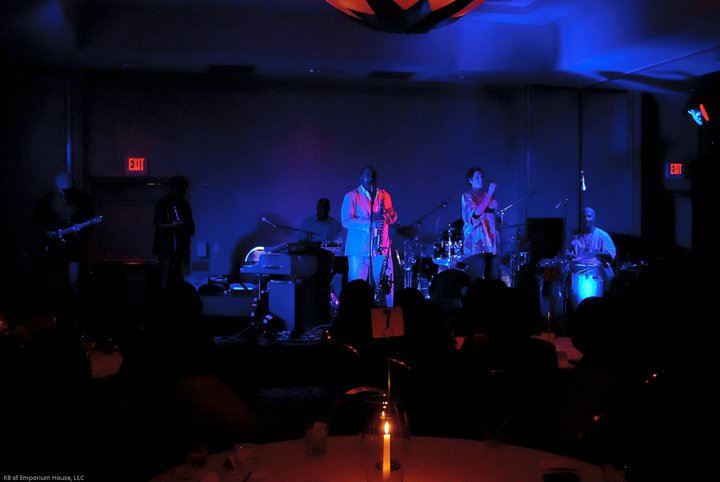 Live band performing under blue stage lighting