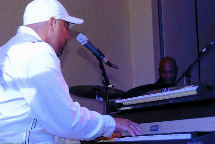 Keyboard player performing with a drummer on stage